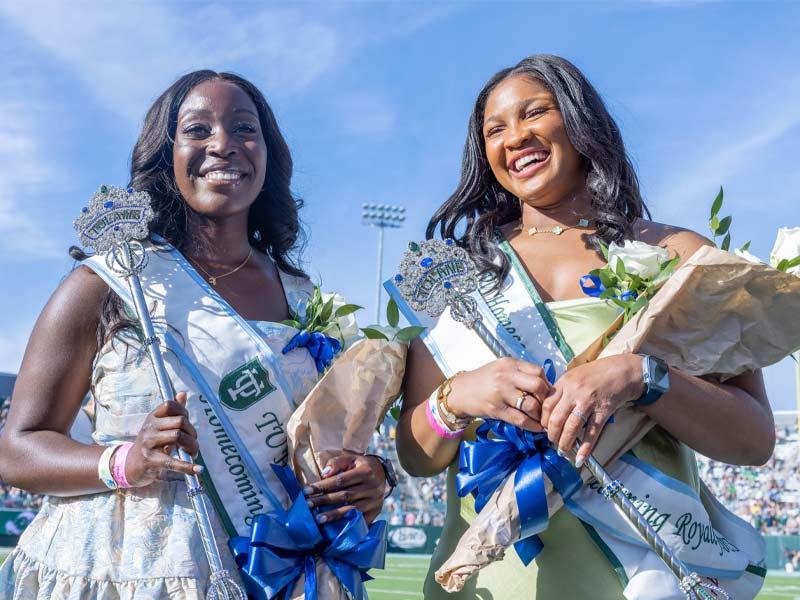 (From left) Seniors Funke Adeleye and Kwesil Ezeh are crowned Homecoming Court Royalty during halftime of the football game.