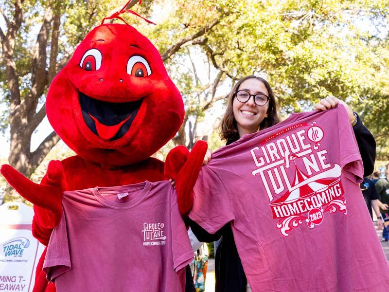 A friendly mudbug helps to give away “Cirque de Tulane” T-shirts at the event.