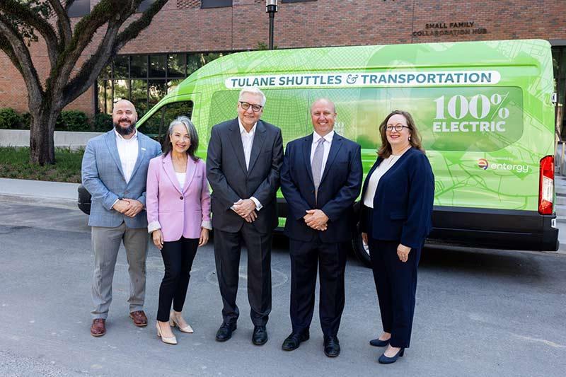 (From left to right) Scott Barrios, the manager of Entergy’s electric mobility portfolio; Entergy New Orleans CEO Deanna Rodriguez; Tulane COO Patrick Norton; Brian Lowe, director of Tulane shuttles and transportation; and Jordan Stewart, director of the Tulane office of sustainability, gathered in front of the Small Family Collaboration Hub on McAlister Drive to celebrate the collaborative efforts that have brought electric vehicles to Tulane University.