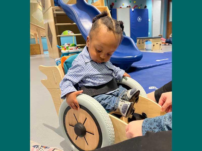 Young patient tries out his new trainer made by Tulane students