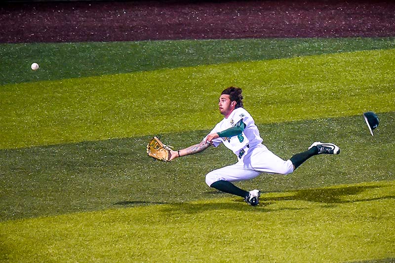Outfielder Lex Kaplan goes for a sliding catch during Tulane’s home series against the University of San Diego Toreros over the weekend.