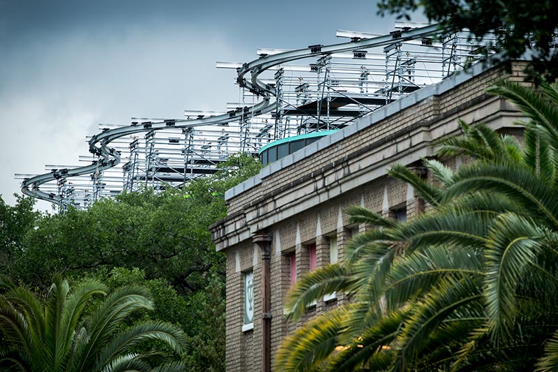 The metal structure of the expansion to the A.B. Freeman School of Business rises above oak and palm trees on the uptown campus. The metal structure of the expansion to the A.B. Freeman School of Business rises above oak and palm trees on the uptown campus.