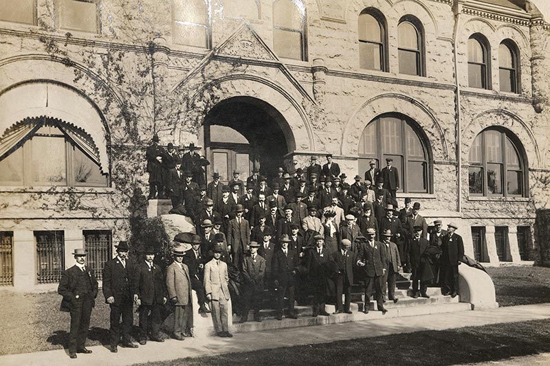 An anonymous group is captured on the steps of Gibson Hall.