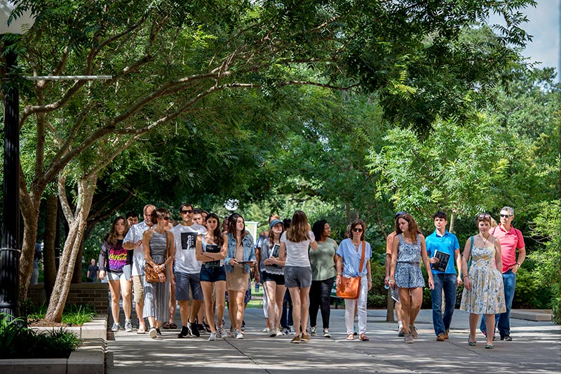 Visitors learn about life at Tulane during a walking tour across campus.