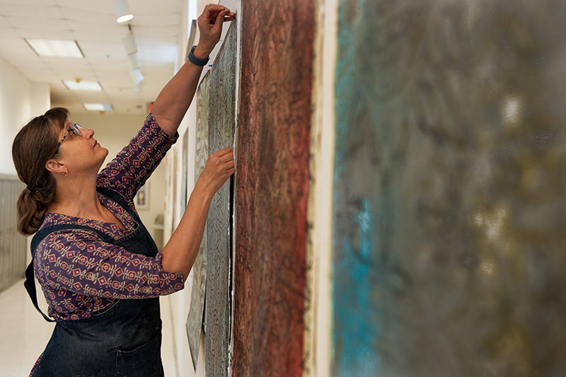 Teresa Cole, professor and chair in the Newcomb Art Department, works on a new series called “Rejects.” 