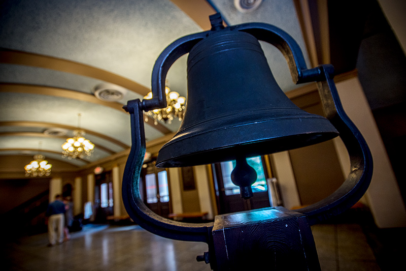 The Newcomb bell stands in the cool darkness of the Dixon Hall lobby. Historical bell continues to ring in tradition.