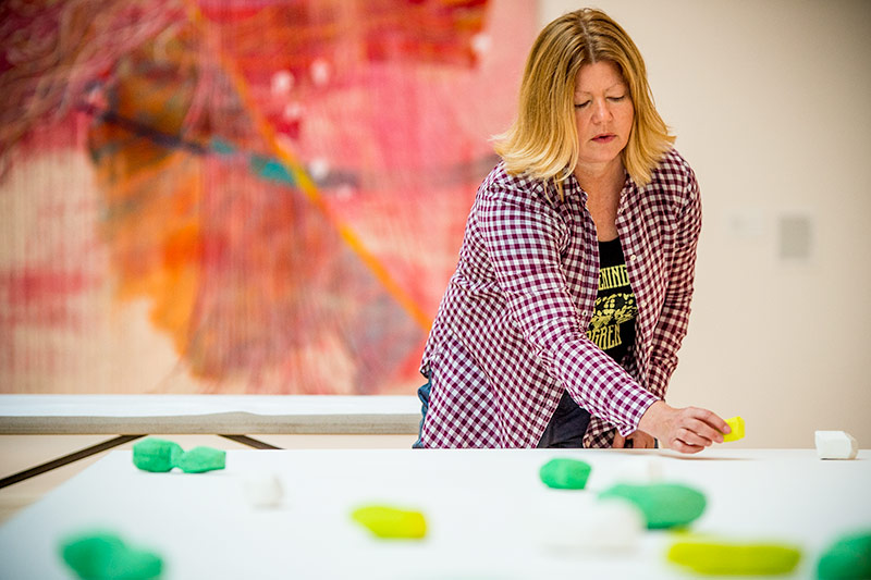 Artist makes sure all the pieces are positioned properly while installing her sculpture in the Newcomb Art Museum. 