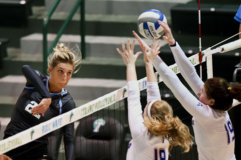 Junior outside hitter Sarah Ray hits through two Tulsa blockers in Avron B. Fogelman Arena in Devlin Fieldhouse.