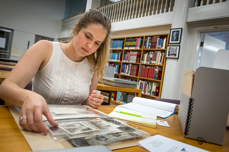 Kathryn Clinard examines a box of photographs in the reading room at the Amistad Research Center in Tilton Hall. 