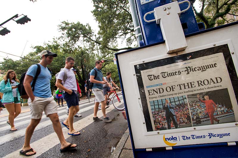 Tulane students walk by a Times-Picayune newspaper rack on election day, Tuesday (Nov. 8).