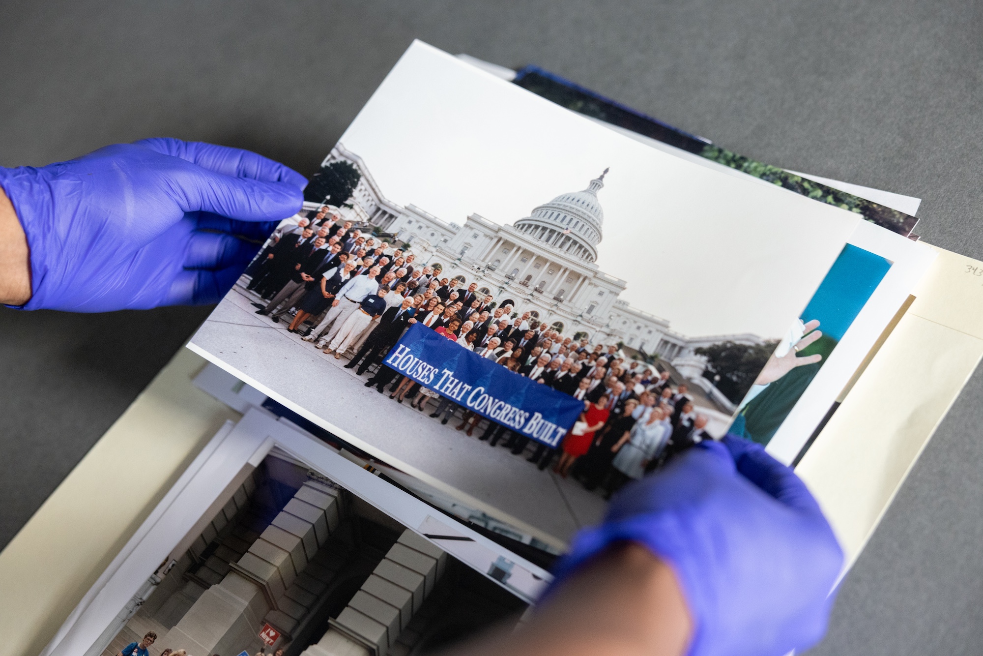 Archivist holds a printed photo of Capitol building