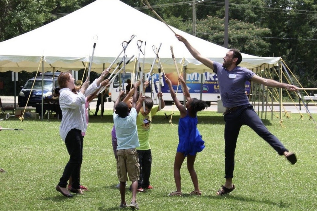 Tunica Language and Culture Youth Camp volunteers and campers play stickball.