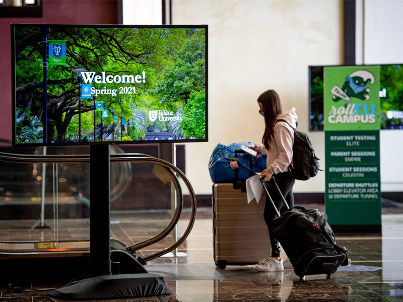 A student wheels her luggage through the Arrival Center at the Hyatt Regency Hotel in New Orleans ahead of moving on to campus for the spring 2021 semester
