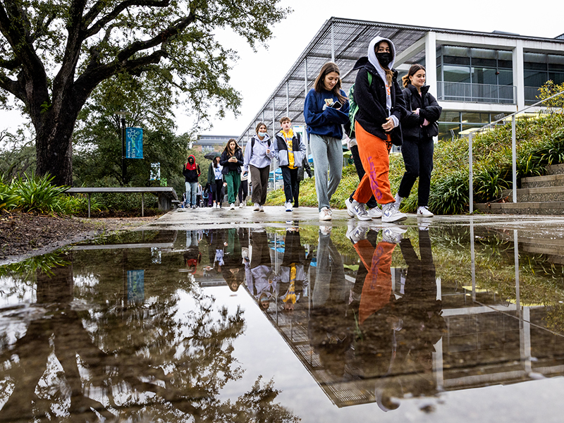 Students walk to their classes on the first day of the spring semester on a cold, wet morning. 