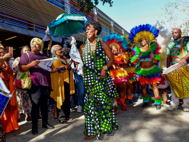 Carolyn Barber-Pierre leads a second-line, followed by members of Casa Samba, the dance troupe she founded, to Richardson Building, the location of the Center for Intercultural Life.