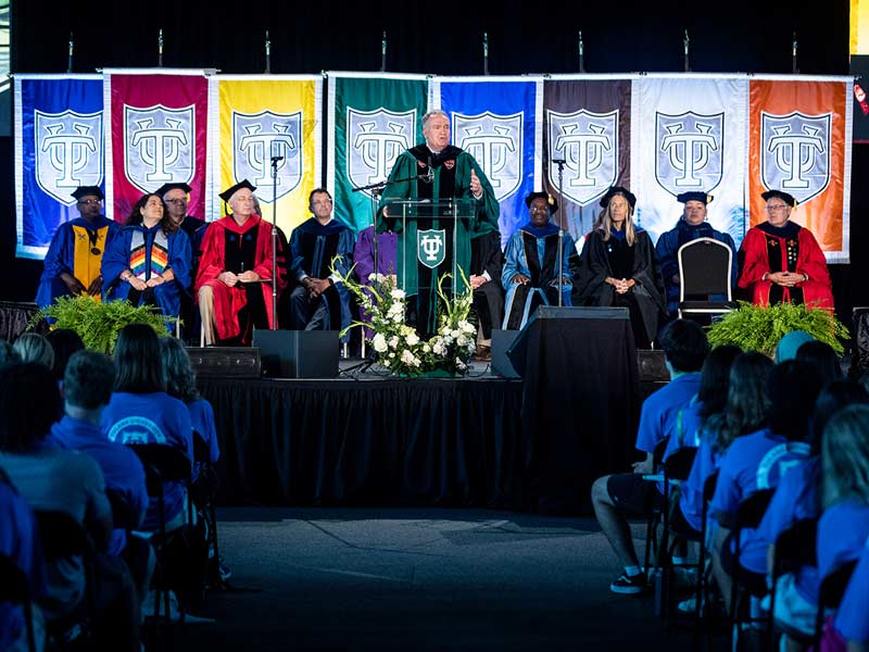Tulane President Michael Fitts, surrounded by deans of the schools and other administrators, speaks to the Class of 2026. 