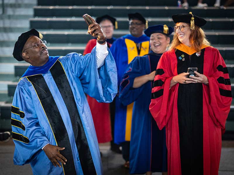  Thomas LaVeist, dean of the School of Public Health and Tropical Medicine, stops during the second-line to take a quick selfie with the new class. 