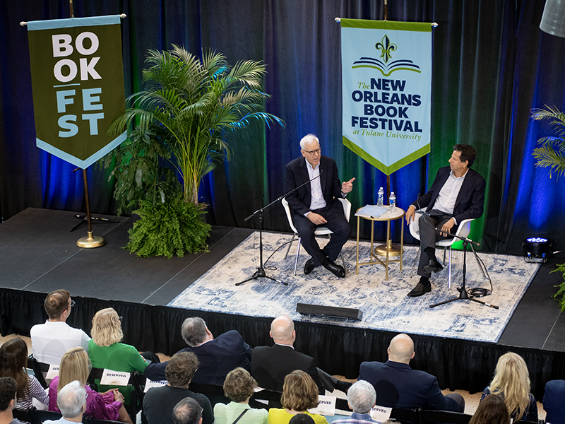 David Rubenstein, left, answers questions from author Gary Ginsberg, right, about his career in the Carter White House and his path to becoming a successful investor. 