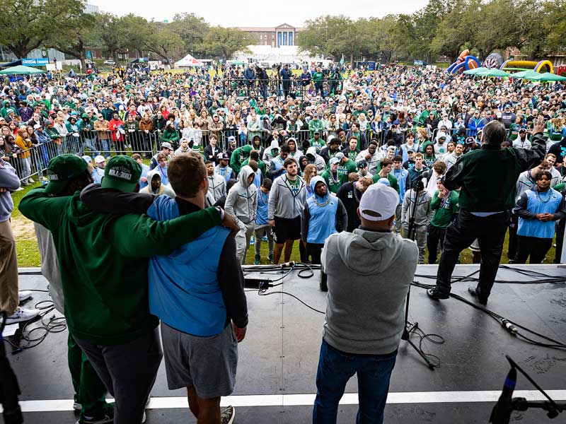 President Fitts (far right) addresses the crowd, congratulating the Green Wave on its historic season and thanking fans for the support.. 