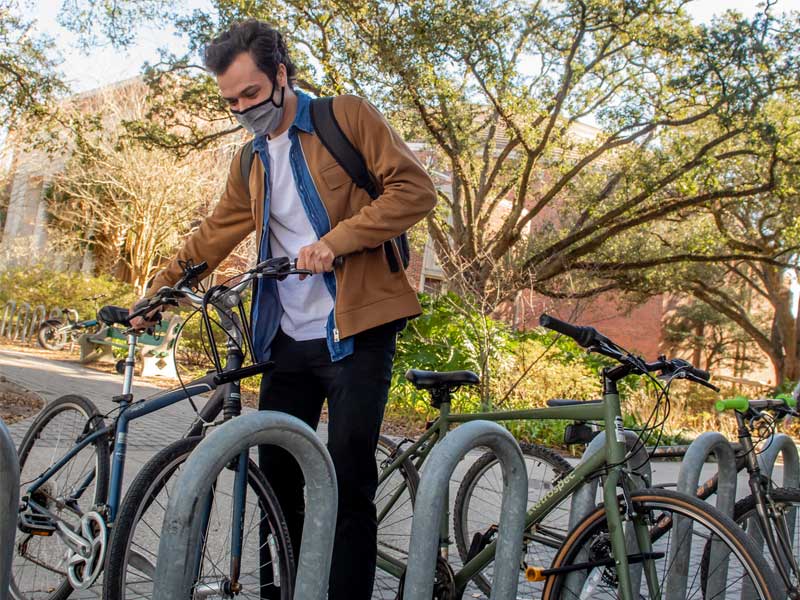 Fourth-year student Grant Little unlocks his bike after his morning class. 