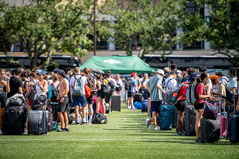 Students line up on Brown Field on Tulane's campus to board buses headed to Houston. 