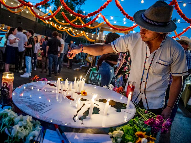 Tulane architecture professor Javier Marcano, lights candles on an altar dedicated to Latin American resistance fighters during the Latine Arts Fest on Saturday, Oct 1.