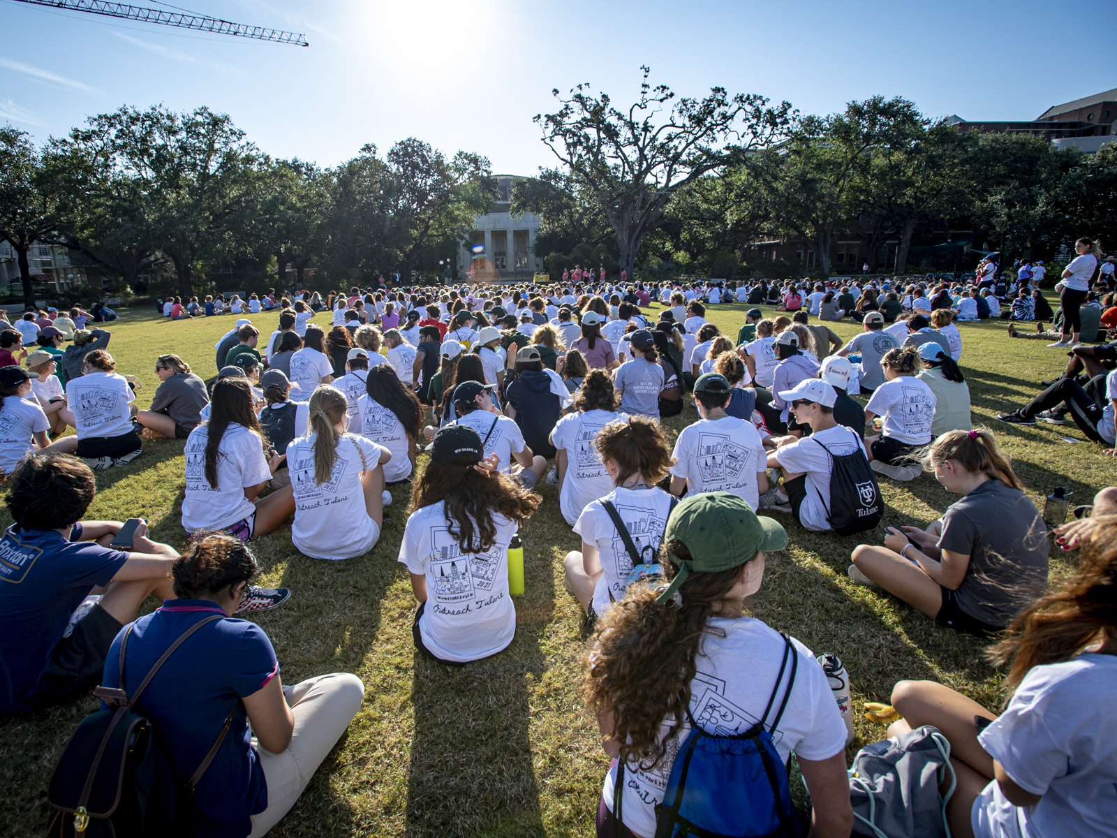 The sun rises as students gather on the Berger Family Lawn before loading buses to the various service locations. 