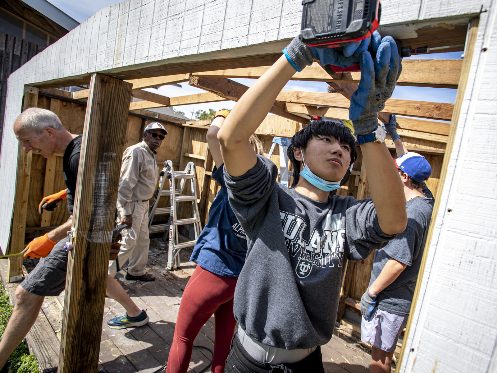 Tulane junior Michael Xu helps secure an aging shed at Hagar’s House NOLA which provides transitional housing and resources for women and children.
