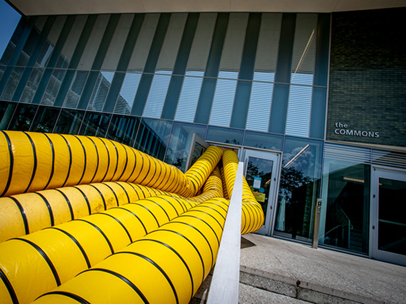 Temporary HVAC tubes powered by generators provide temporary air condition to buildings on campus. 
