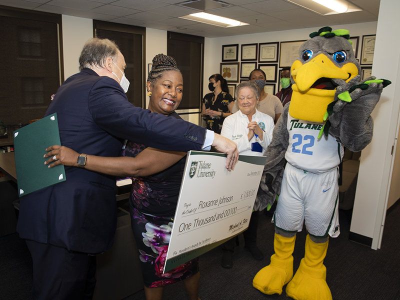 Roxanne Johnson, director of the Human Research Protection Office, hugs President Fitts upon receiving the President's Staff Excellence Award. 