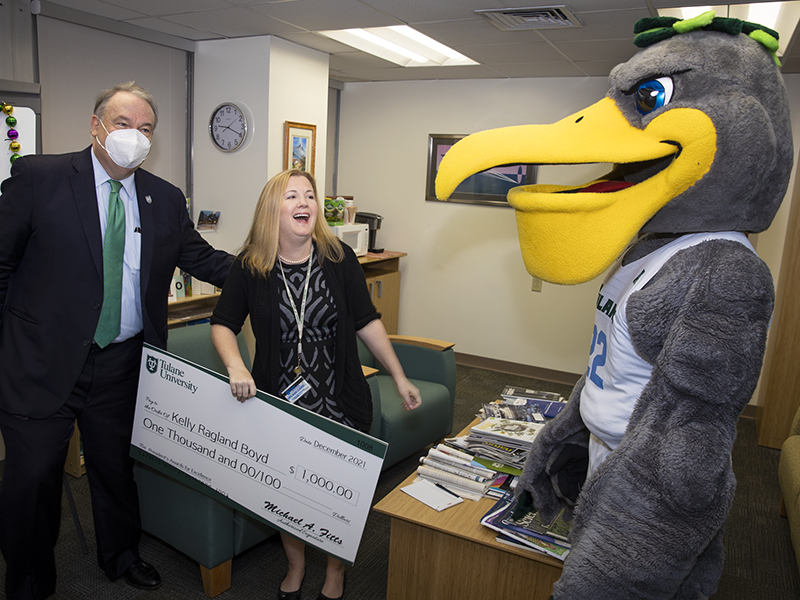 Kelly Ragland Boyd laughs with President Fitts and Riptide during the surprise award delivery. 