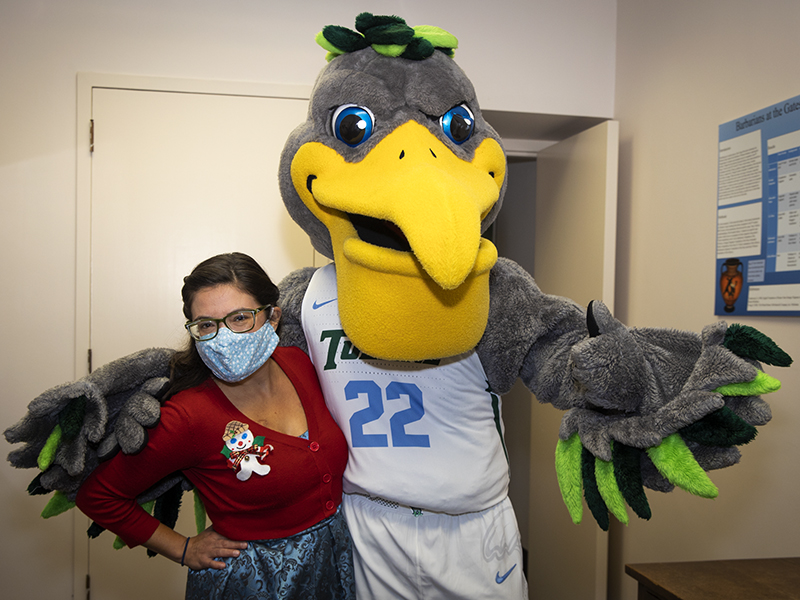 Elizabeth Reyna, executive secretary for the Department of Classical Studies at the School of Liberal Arts, poses with Riptide. 