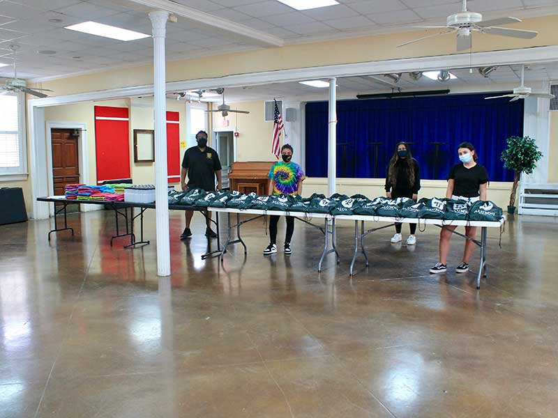 Tulane volunteers with care packages given to local grade-school music students