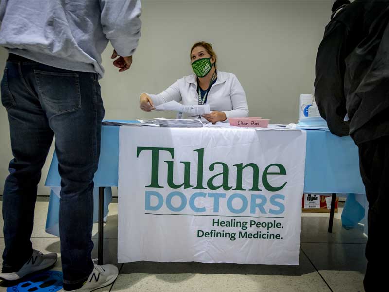 Tulane nurse Stacey Barbaro hands out consent forms, including detailed information about the Pfizer-BioNTech COVID-19 vaccine.