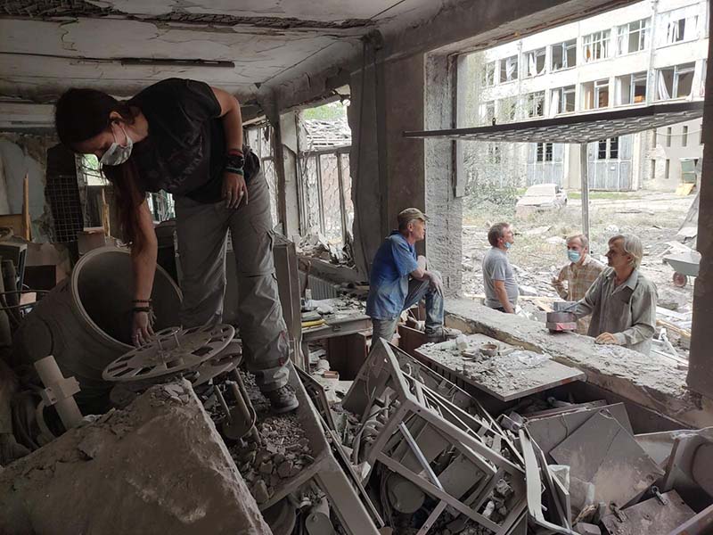 Woman salvaging equipment from bombed lab