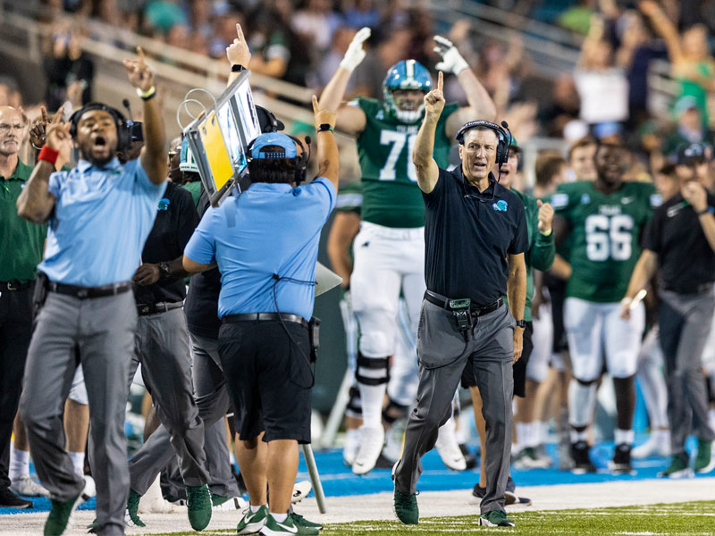 Tulane head football coach Willie Fritz, coaching staff and teammates celebrate a touchdown 