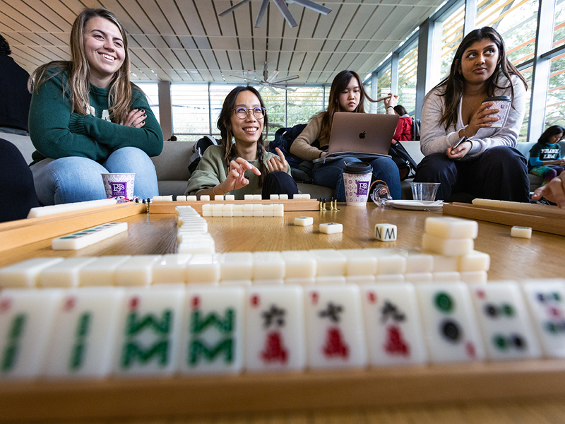 Students play a tradition Chinese game, mahjong, during the event.