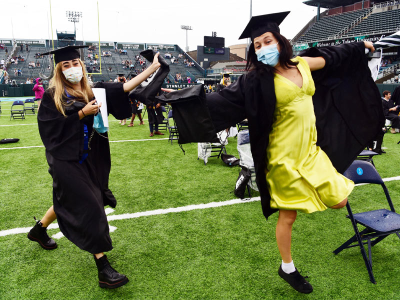 Students show their excitement at the School of Liberal Arts Commencement ceremony held in Yulman Stadium. 