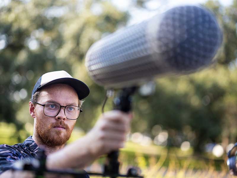 James May, adjunct professor in the Newcomb Department of Music, adjusts a shotgun mic during a Creative Soundscape class at Audubon Park on Monday afternoon. The class introduces approaches to music and media that incorporate environmental sound. 