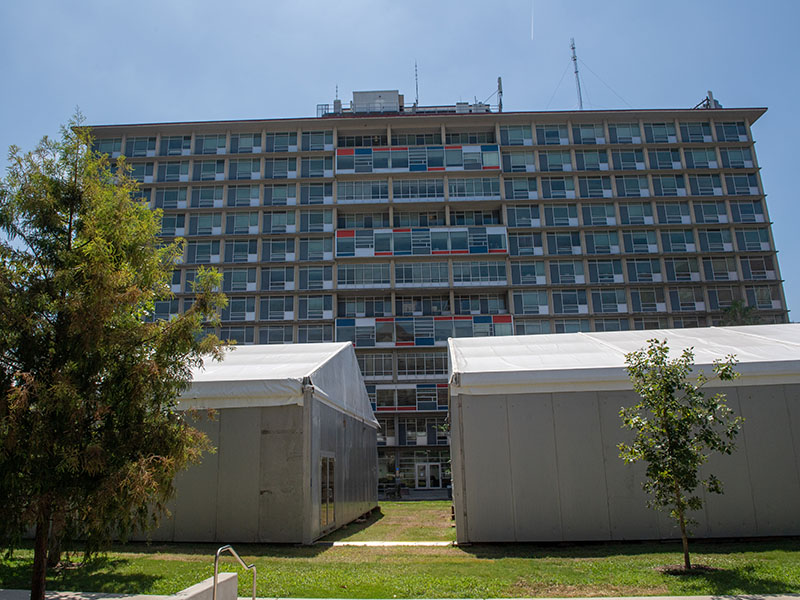 Temporary classroom buildings have been built on Monroe Quad, with Monroe Hall in the background.