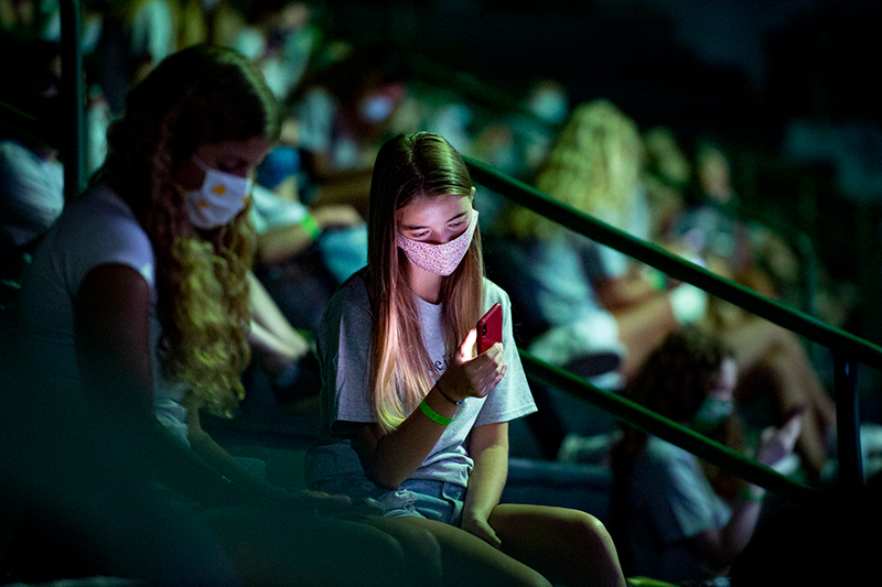 Chloe Chace from London checks her phone before silencing it at the start of the event. (Photo by Paula Burch-Celentano) 