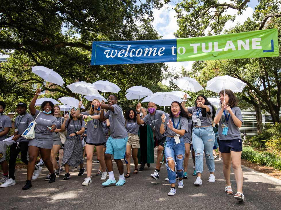Photo of new students leaving Convocation under a banner that reads "Welcome to Tulane."