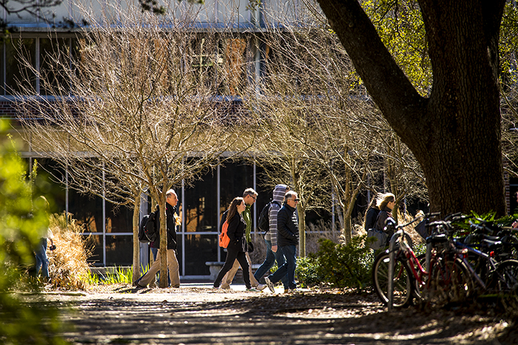 Admissions office interns guide visitors through campus. 