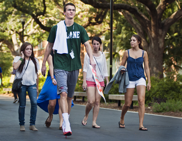 Tall guy in heels walks with women