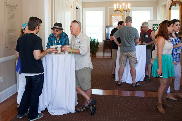 Inside the alumni house, folks reconnect with friends and make new ones as they dine on New Orleans cuisine.