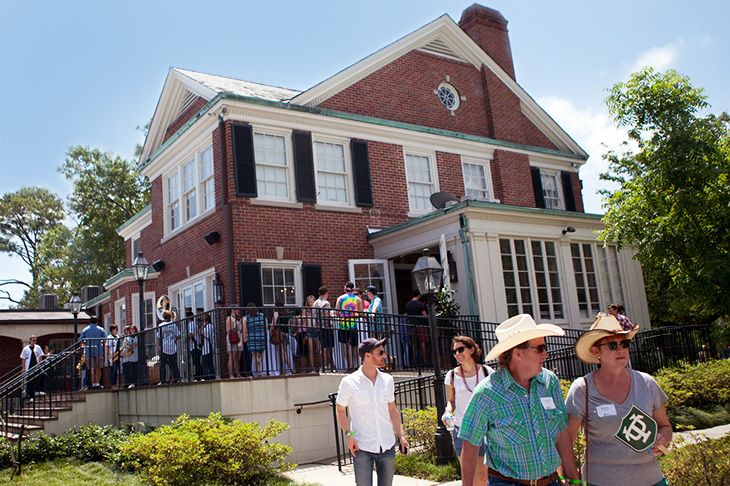 Straw hats are de rigeur as revelers head to the shuttle bus that will take them to the Jazz Fest.