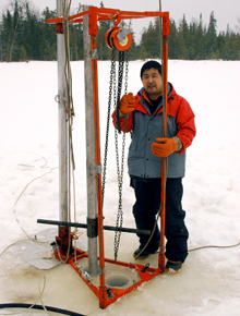 Shiyong Yu, Tulane postdoctoral fellow in earth and environmental sciences, hoists a core sample from Surprise Lake on the Sibley Peninsula, Ontario, Canada. (Photos from Shiyong Yu)