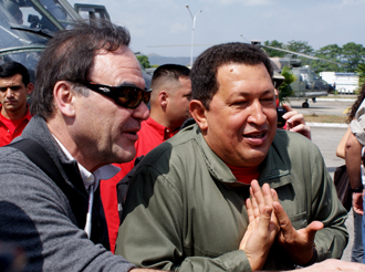 Director Oliver Stone, left, and Venezuela president Hugo Chavez, right, meet news media during filming of South of the Border. (Photo by Jose Ibanez)