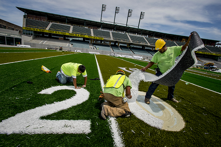 The turf goes down in Yulman Stadium.