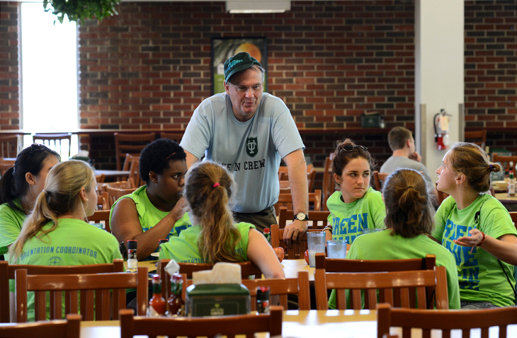 Tulane President Michael Fitts chats with members of the Green Wave Move-In Krewe